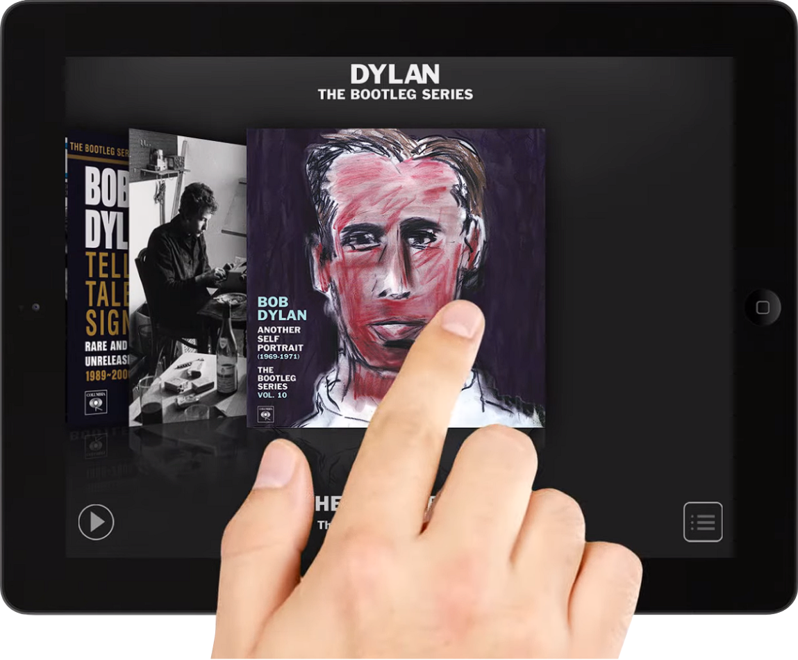 A hand swiping on a tablet through a carousel of images of Bob Dylan's album covers on Bob Dylan's The Bootleg Series app..